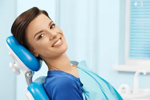 Patient smiling in dental chair before braces tightening appointment